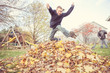 © soupstock - Boy taking a break from chores to jump in the leaves