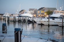 Fancy boats and yachts in Nantucket Island harbor at evening