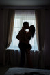 © DenisProduction.com - Couple kissing and hugging. Man and woman beside window. Don't restrain your passion.