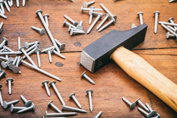 Wall Mural - Hammer and nails on wooden background