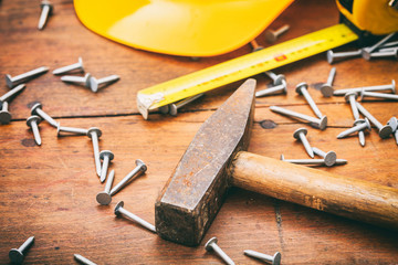 Wall Mural - Hammer and nails on wooden background