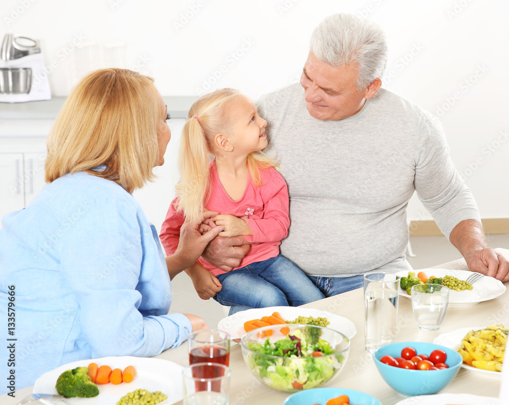 Happy family having lunch in kitchen