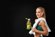 © Africa Studio - Young athletic woman holding bottle with water on black background