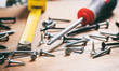 © Rawf8 - Screwdriver and nails on wooden background