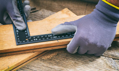 Canvas Print - Carpenter measuring with a metal angle