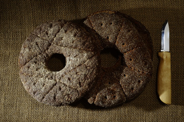 two finnish traditional round ray bread on sackcloth and knife p