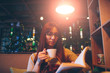 © estradaanton - female is holding open book. Woman  reading a  with coffee or tea