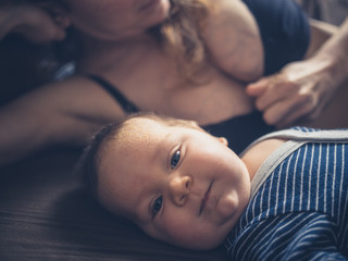 Wall Mural - Cute baby on bed with his mother