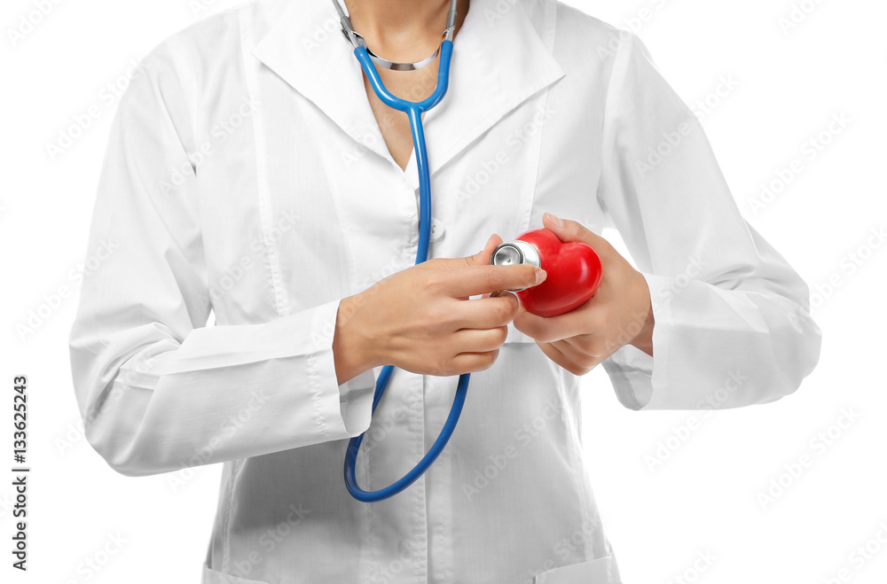 Young female cardiologist holding plastic heart, close up