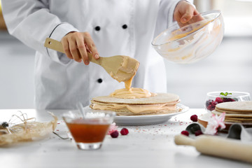 Wall Mural - Cooking concept. Professional confectioner making delicious cake, closeup