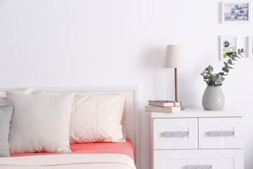 Interior of modern bedroom with cozy double bed