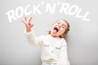Little cute emotional girl in white funny sweater screaming rock'n'roll 