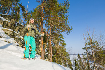 Sticker - Young beautiful woman with snowshoes chill out in the forest