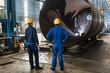 © Kzenon - Workers supervising the manufacture of a metallic cylinder