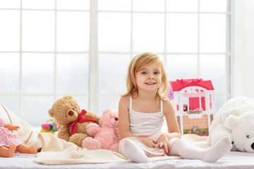 Wall Mural - Joyful female child playing in bedroom