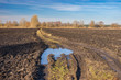 Landscape with agricultural fields and dirty road in central Ukraine at late autumnal season