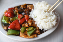 Stir Fry With Rice And Chopsticks On Plate