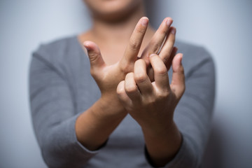 Woman scratching her hand