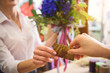 © Yakobchuk Olena - Client giving payment for flowers to saleswoman