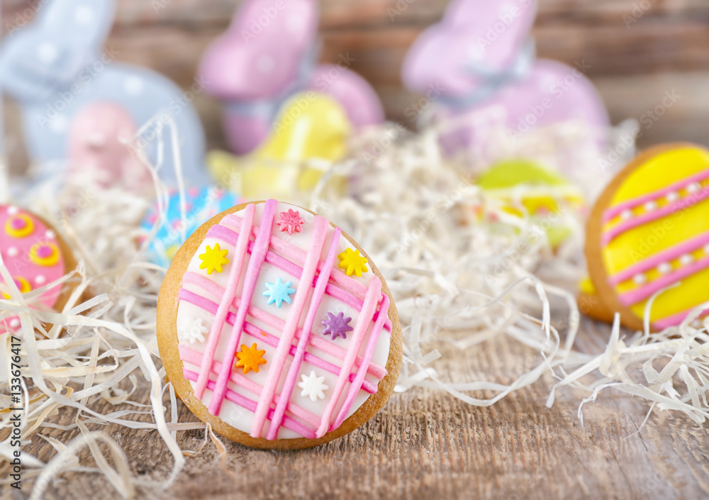 Creative Easter cookies and decorations on wooden table, closeup