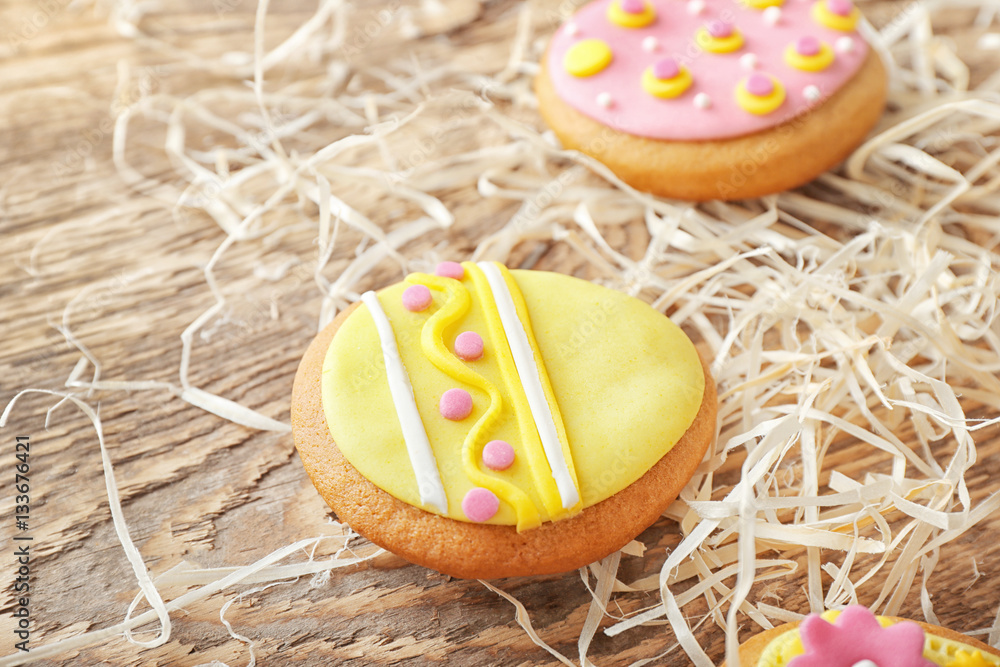 Creative Easter cookies and decorations on wooden table, closeup
