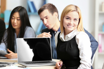 Businesswoman with colleagues in conference room