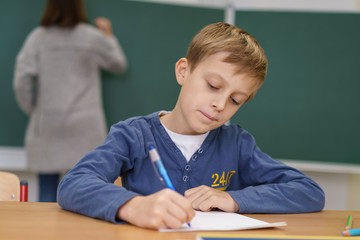 Canvas Print - grundschüler arbeitet am tisch in der klasse