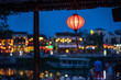 Night view of busy street in Hoi An, Vietnam. Hoi An is the World's Cultural heritage site, famous for mixed cultures and architecture. Focus on paper lantern.