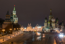 Russia, Moscow. View On A Red Square From The Moskvaretsky Bridge, St. Basil Cathedral On The Right, Kremlin On The Left, State Department Store Is On The Center. Evening, Snow, Winter.