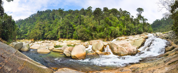 Wall Mural - Waterfall among large boulders in the jungles of Laos