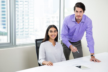 Manager Helping Female Colleague with Documents