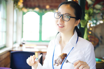  Woman eating juicy meat with sweet sauce in 