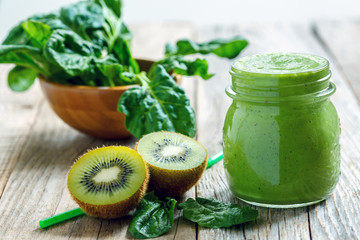 Wall Mural - Healthy green smoothie in jar of spinach, kiwi and celery.