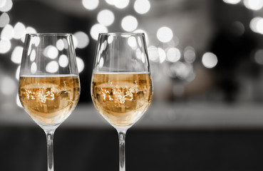 Party time! Pair of wine glasses against a sparkling background.  