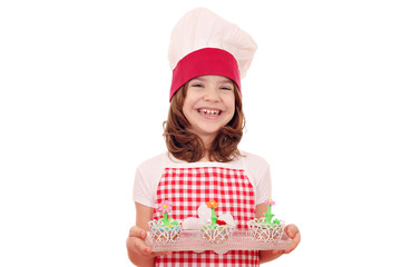 Wall Mural - happy little girl cook with decorated muffin