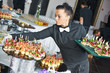 Waitress serving catering table