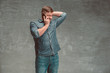 © master1305 - The young smiling caucasian businessman on gray background talking with phone