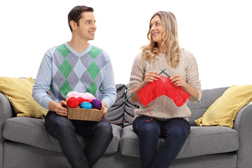 Sticker - Man and woman knitting together on a sofa