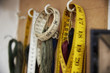 © Mint Images - A row of hooks and tape measures on a tool board.