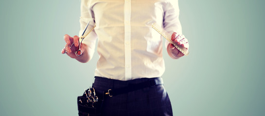 Poster - close up of male stylist with scissors at salon