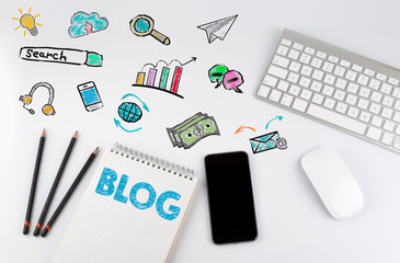 Wall Mural - Blog concept. Office desk table with computer, Smartphone, note pad, pencils.