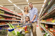 © Syda Productions - family with food in shopping cart at grocery store