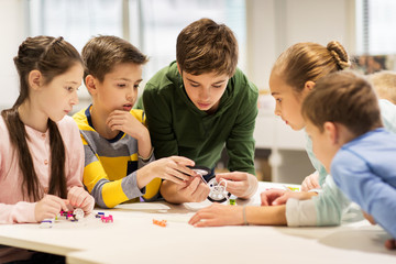 Wall Mural - happy children building robots at robotics school