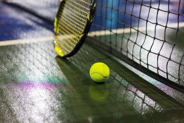 Wall Mural - Tennis ball, racquet and net on wet ground after raining