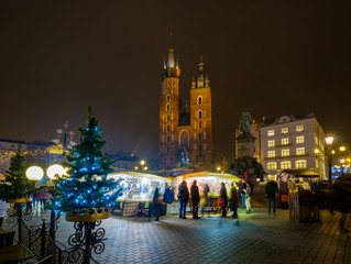 Wall Mural - People visit Christmas market at main square in old city of Krakow, Poland