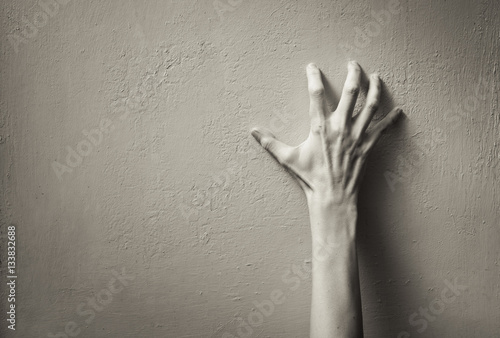 Fotografie, Tablou Hand clawing up a wall. Frustration, and anger concept.