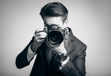 Male Photographer Taking Pictures In Studio.
