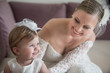 © silalena - Beautiful bride with her little daughter. Summer wedding and baptism. Cute baby girl with her bride mother preparing for the ceremony.
