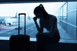 © kieferpix - Sad woman sitting in airport.