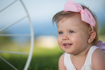 Sweet baby girl playing outdoors. Baptism, Wedding & Fashion